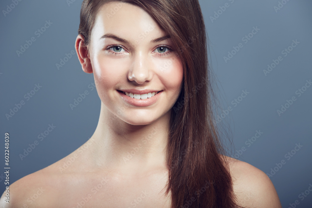Face, skin and beauty portrait of a woman in studio with natural makeup, smile and cosmetics. Happy aesthetic gen z female model on a grey background for glow, hair care and facial dermatology shine Face, skin and beauty portrait of a woman in studio with natural makeup, smile and cosmetics. Happy aesthetic gen z female model on a grey background for glow, hair care and facial dermatology shine