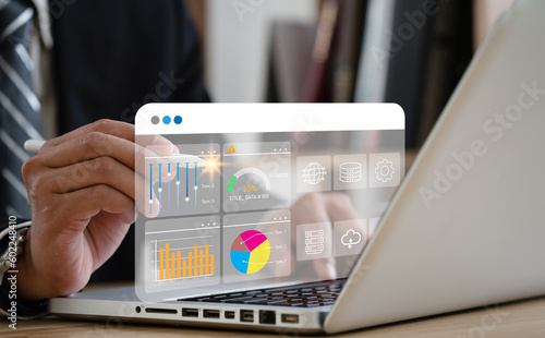Business strategy concept for the development of the organization. Businessman use laptops to work on virtual smart digital screens, Analyze statistical Marketing data,Data management