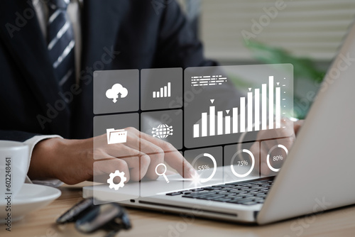 Business strategy concept for the development of the organization. Businessman use laptops to work on virtual smart digital screens, Analyze statistical Marketing data,Data management
