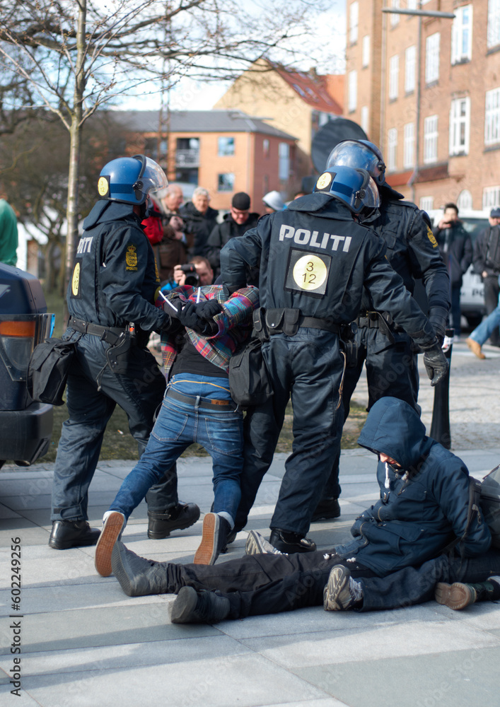 Police men, criminal and arrest in the city of Denmark for street safety, security or law enforcement. Group of legal government officers arresting people in a urban town for crime, justice or riot Police men, criminal and arrest in the city of Denmark for street safety, security or law enforcement. Group of legal government officers arresting people in a urban town for crime, justice or riot