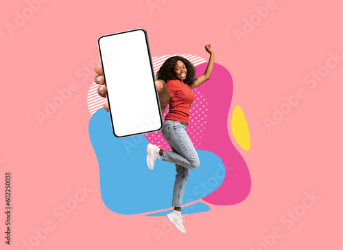Excited Black Woman Jumping With Big Blank Smartphone Over Colorful Abstract Background