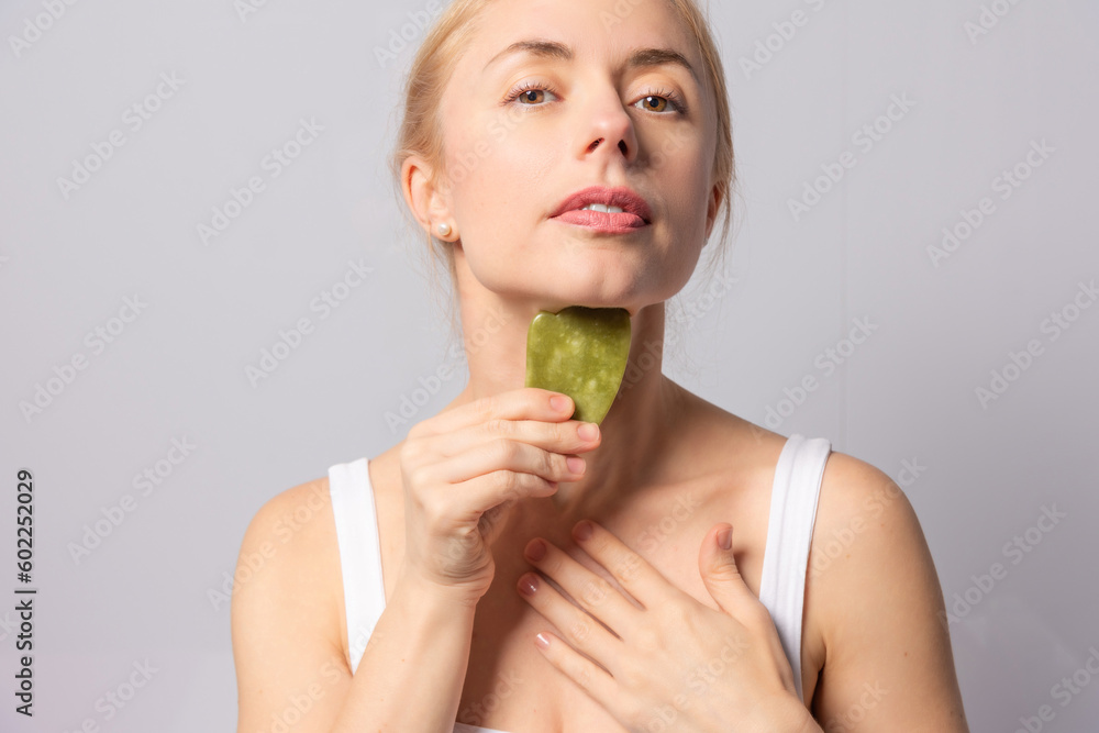 The girl performs gouache massage, brush and vacuum massages for facial skin lifting and rejuvenation The girl performs gouache massage, brush and vacuum massages for facial skin lifting and rejuvenation