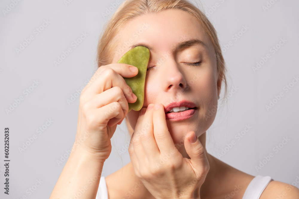 The girl performs gouache massage, brush and vacuum massages for facial skin lifting and rejuvenation The girl performs gouache massage, brush and vacuum massages for facial skin lifting and rejuvenation
