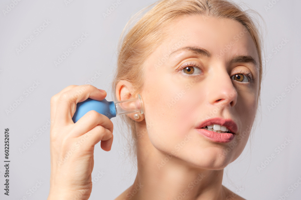 The girl performs gouache massage, brush and vacuum massages for facial skin lifting and rejuvenation The girl performs gouache massage, brush and vacuum massages for facial skin lifting and rejuvenation