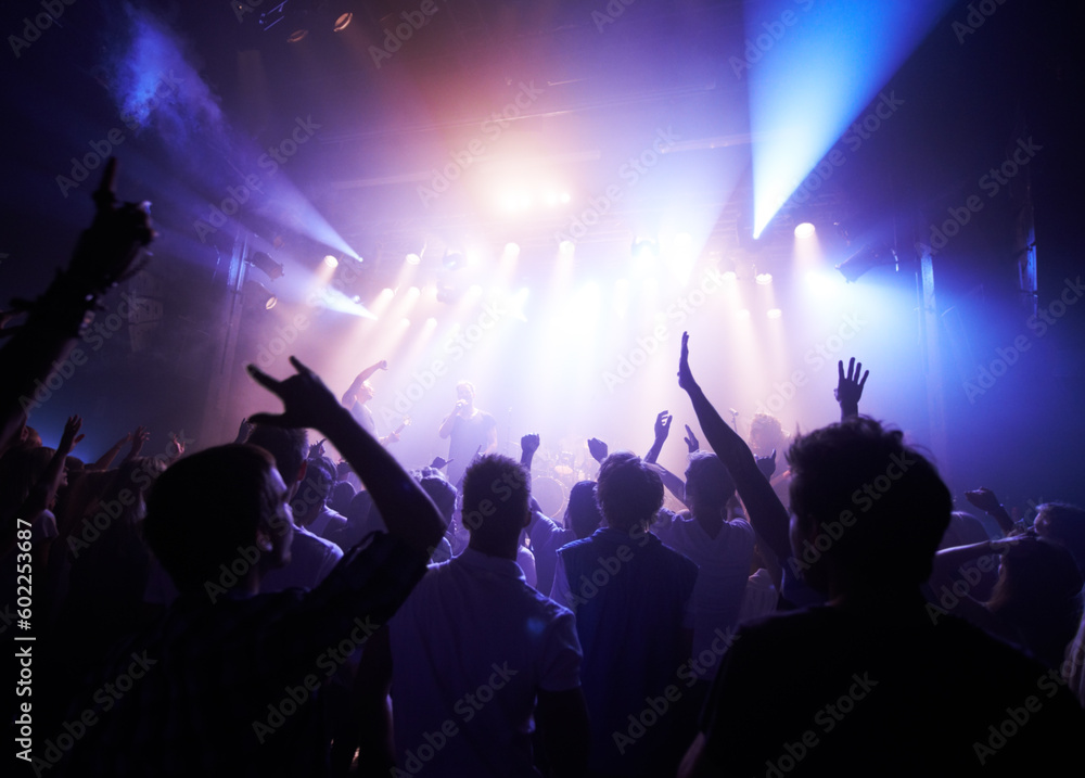Music, dance and party with crowd at concert for rock, live band performance and festival show. New year, celebration and disco with audience of fans listening to techno, rave and nightclub event Music, dance and party with crowd at concert for rock, live band performance and festival show. New year, celebration and disco with audience of fans listening to techno, rave and nightclub event