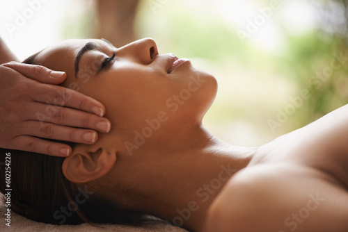 Woman, hands or head massage to relax in spa for zen resting, sleeping wellness or luxury physical therapy. Face of girl in salon to exfoliate for facial healing treatment, beauty or holistic detox photo