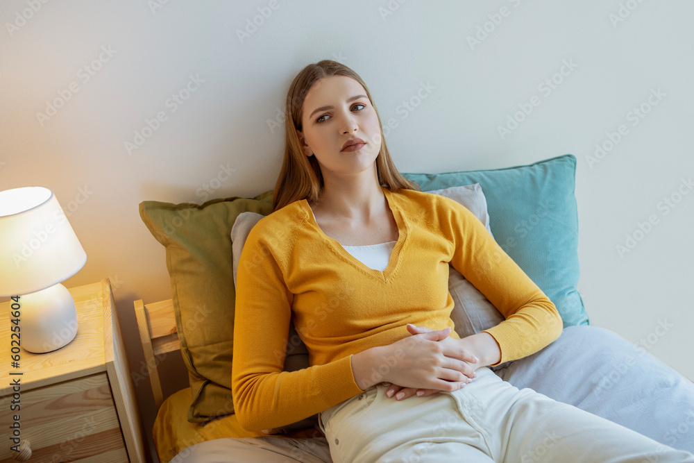 Young Woman Struggling With Menstrual Cramps And Pain Lying Indoors Young Woman Struggling With Menstrual Cramps And Pain Lying Indoors