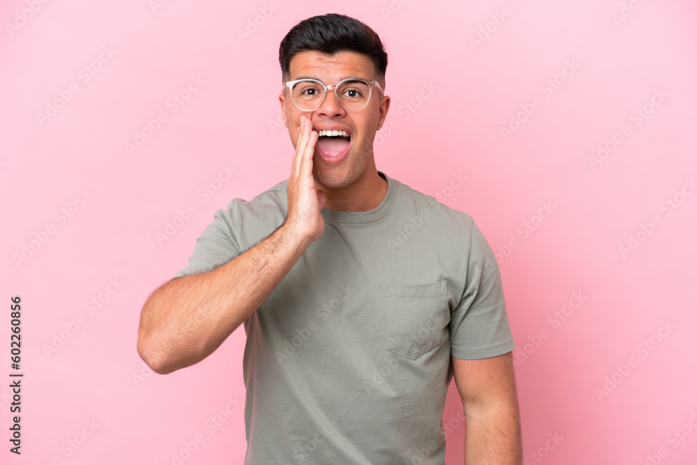 Young caucasian handsome man isolated on pink background with surprise and shocked facial expression Young caucasian handsome man isolated on pink background with surprise and shocked facial expression