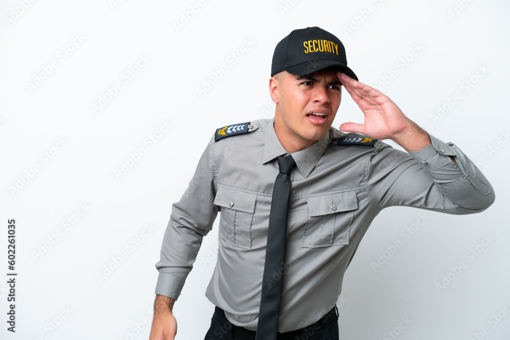 Young caucasian security man isolated on white background looking far away with hand to look something Young caucasian security man isolated on white background looking far away with hand to look something