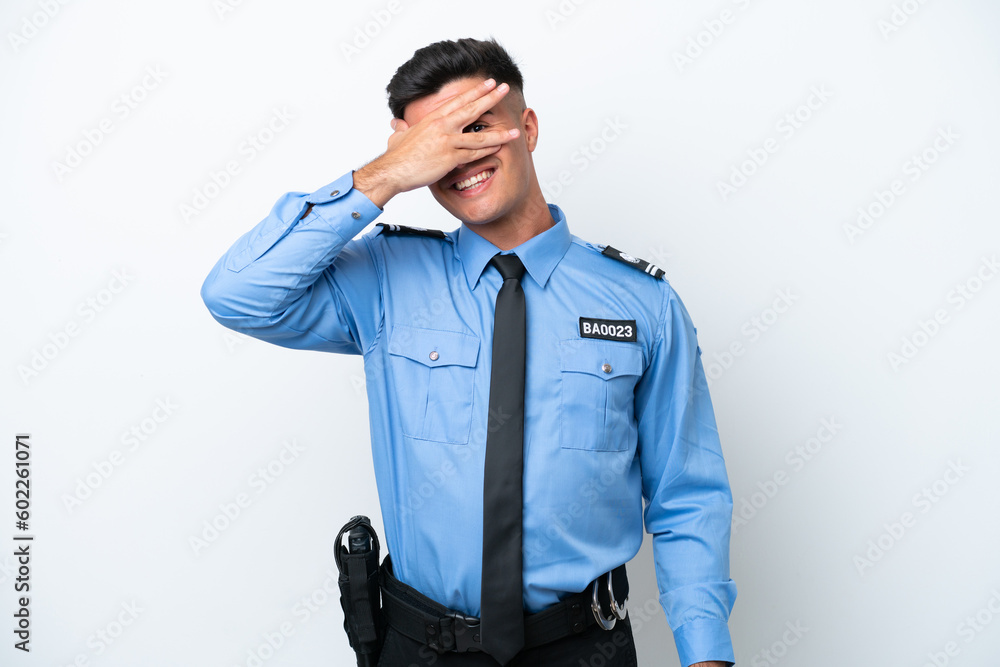 Young police caucasian man isolated on white background covering eyes by hands and smiling Young police caucasian man isolated on white background covering eyes by hands and smiling