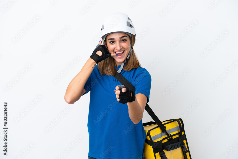 Young caucasian woman with thermal backpack isolated on white background making phone gesture and pointing front Young caucasian woman with thermal backpack isolated on white background making phone gesture and pointing front