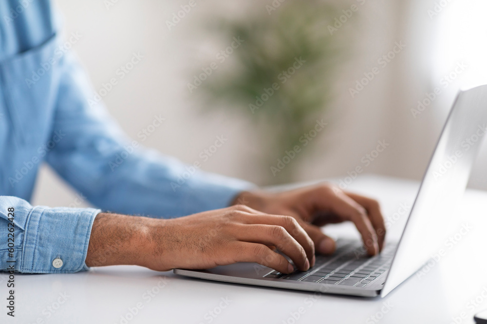 Unrecognizable Male Working With Laptop At Desk In Office Unrecognizable Male Working With Laptop At Desk In Office