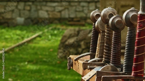 swords axes and spears in a rack during a historical reenactment