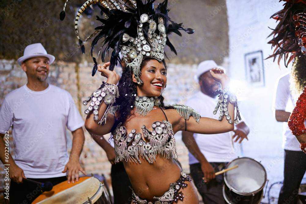 Carnival, dance and cultural female dancer performing with band at mardi gras or exotic festival. Performance, costume and woman dancing with rhythm to live music for entertainment in Rio de janeiro.