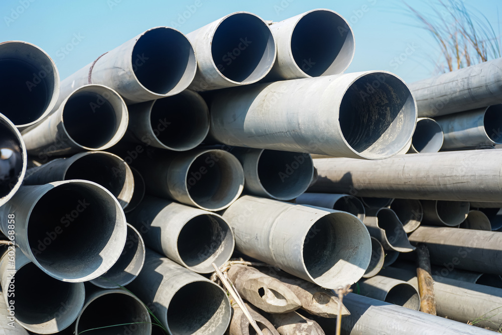 Background of big plastic pipes used at the building site.The many big pipes on the ground. PVC pipes bacground Background of big plastic pipes used at the building site.The many big pipes on the ground. PVC pipes bacground