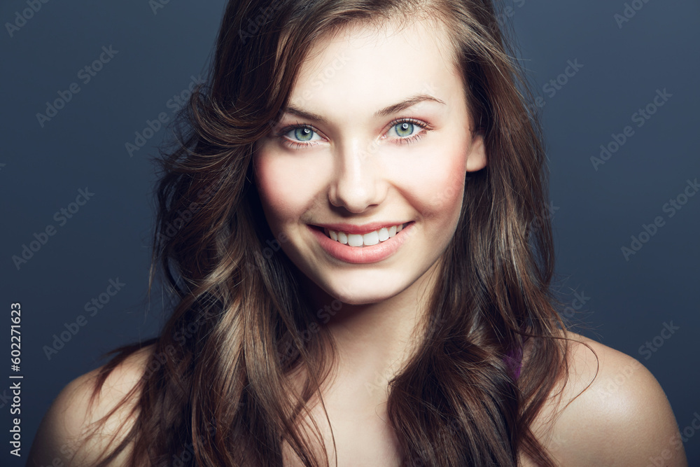 Obraz premium Beauty, natural and portrait of happy woman in studio with makeup, facial and skincare routine. Health, smile and face of young female model with cosmetic or dermatology treatment by blue background.