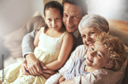 Smile, relax or happy grandparents with a children hug to embrace love together in family home in retirement. Elderly grandma, old man or kids relaxing, bonding or enjoying quality time together #602272088