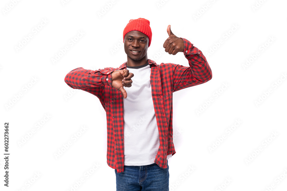 young african man in red plaid shirt showing like and dislike over isolated white background young african man in red plaid shirt showing like and dislike over isolated white background