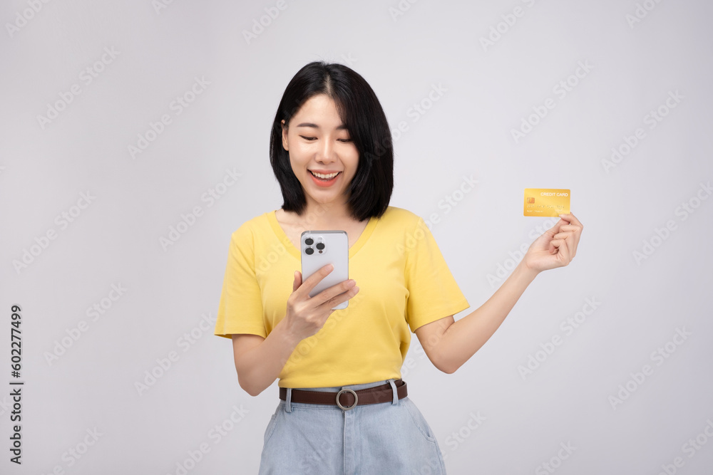 Portrait of happiness Asian girl use smart phone wear yellow shirt on white color background Portrait of happiness Asian girl use smart phone wear yellow shirt on white color background