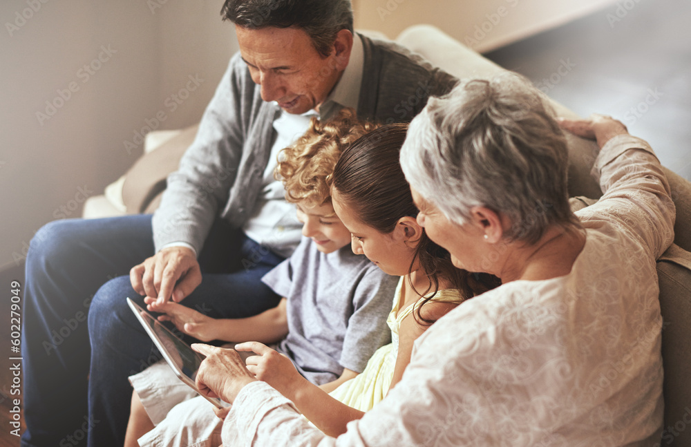 Obraz premium Tablet, children or grandparents streaming movie or film on online subscription in retirement at home together. Kids siblings, relaxing or grandmother loves watching fun videos with a senior old man