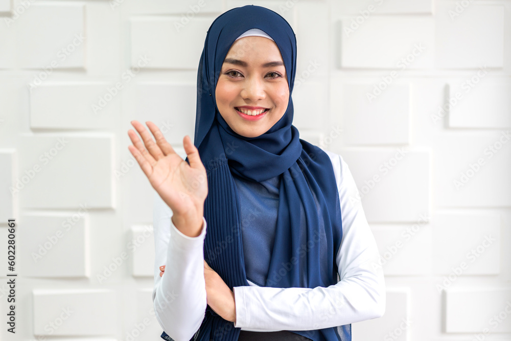 Beautiful happy confident asian muslim businesswoman smart looking at camara on office workplace desk.Young muslim creative coworkers business people working and planning