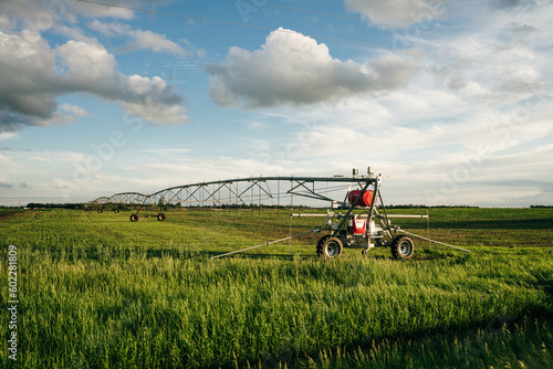 Watering in a large field using a self-propelled sprinkler system with a center swing.