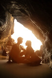 Portrait of happy couple, embracing in the hidden cave at the Querim beach, North Goa, India.