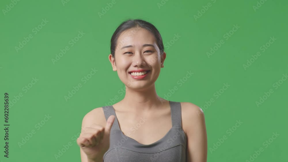Close Up Of Asian Woman Wearing Sportswear And Looking At Smartphone Then Screaming Goal Celebrating On Green Screen Background In The Studio
Close Up Of Asian Woman Wearing Sportswear And Looking At Smartphone Then Screaming Goal Celebrating On Green Screen Background In The Studio