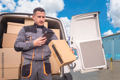 Courier near minivan. Man d...