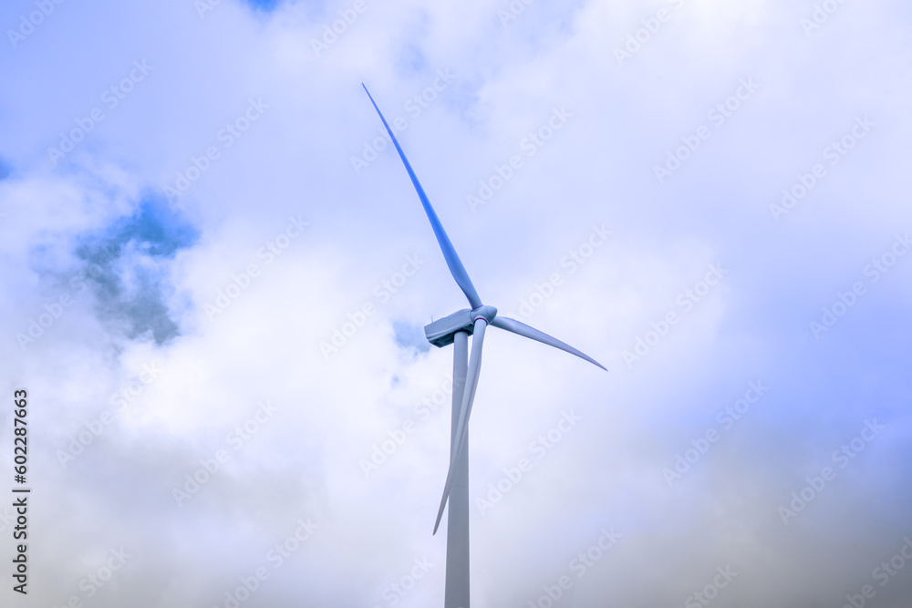 Wind turbine generating electricity clean energy with cloud and sunlight background on the sky. Clean energy concept. Wind turbine generating electricity clean energy with cloud and sunlight background on the sky. Clean energy concept.