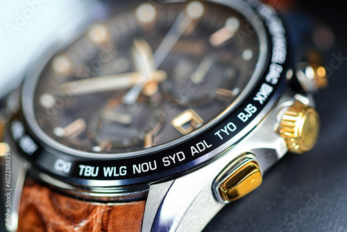 close up shallow focus Time zone cities code on luxury world time  watch bezel, SYD Sydney, ADL Adelaide, NEU Neumea, TYO Tokyo. photo