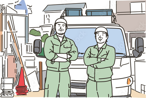 トラックの前で腕組みをする作業員の男性達
