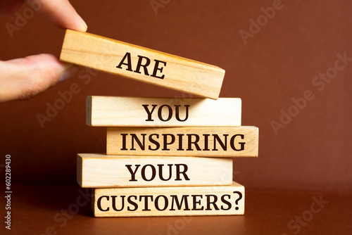 Wooden blocks with words 'Are You Inspiring Your Customers?'.