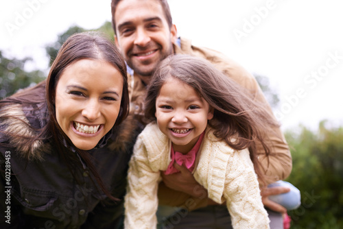 Family, kids and hug in park portrait with mom, dad and girl together with happiness and smile. Outdoor, face and summer vacation of a mother, father and kid with bonding, parent love and child care