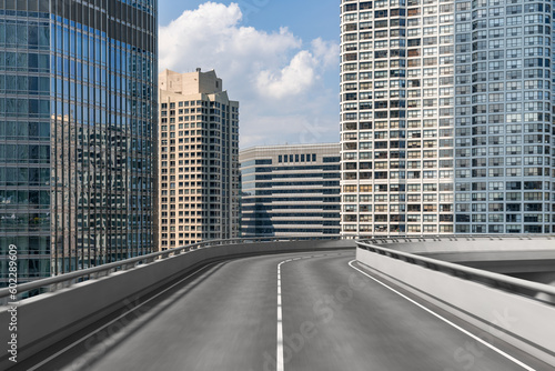Empty urban asphalt road exterior with city buildings background. New modern highway concrete construction. Concept of way to success. Transportation logistic industry fast delivery. Chicago. USA.