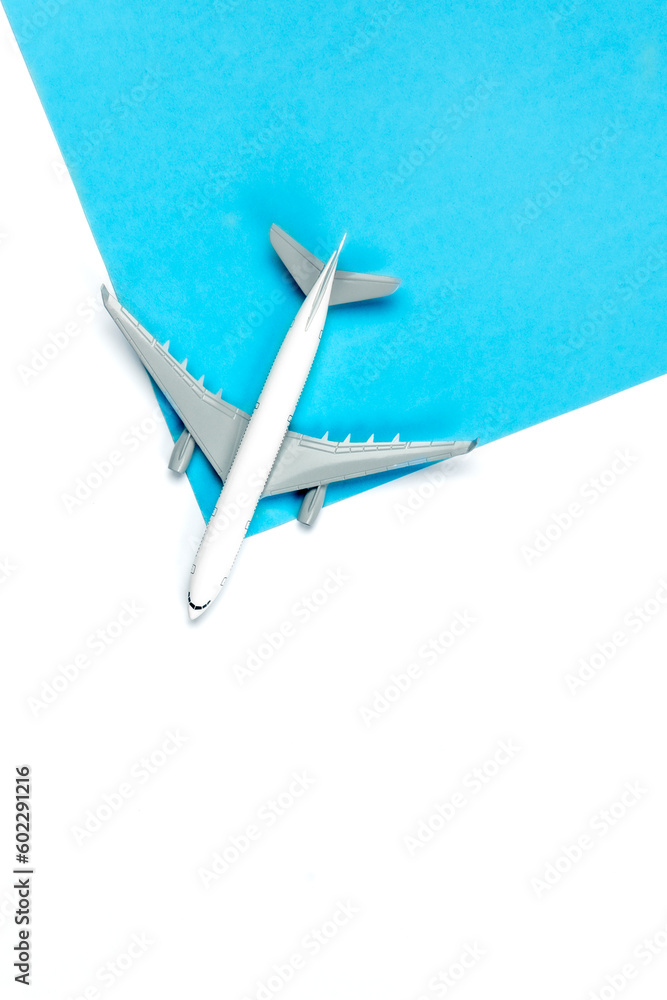 Airplane model on a blue and white background, top view.