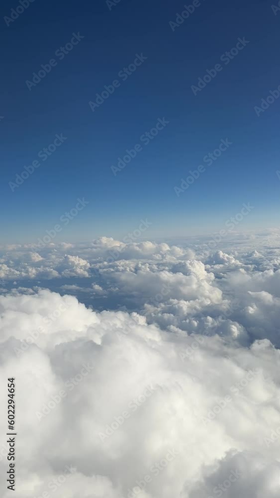 Airplane flight. Flying above the clouds. View from the window of the plane. Traveling by air Airplane flight. Flying above the clouds. View from the window of the plane. Traveling by air