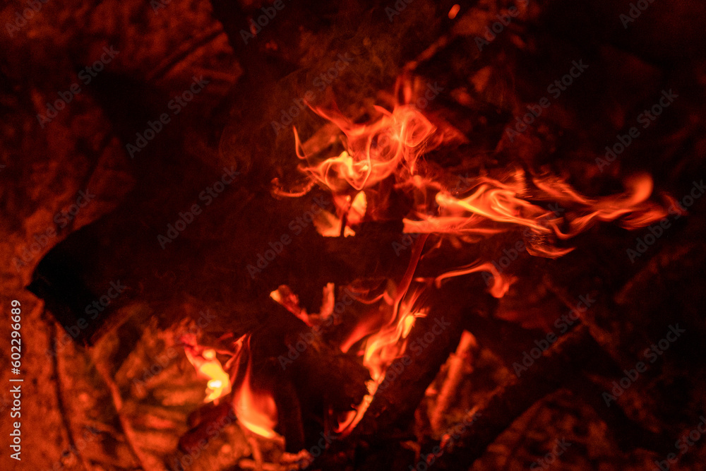 Close up shots of flames and natural wood in an outdoor fire pit at Night Close up shots of flames and natural wood in an outdoor fire pit at Night