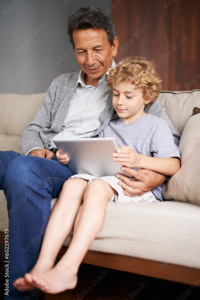 Tablet, child or grandpa streaming movie or film on online subscription in retirement at home to relax. Family, grandfather or kid loves watching fun videos with a senior or mature old man on sofa