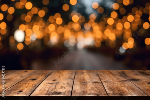 An empty brown rustic wooden table with a blurred Christmas bokeh background. Warm evening background for product presentation or copy space.