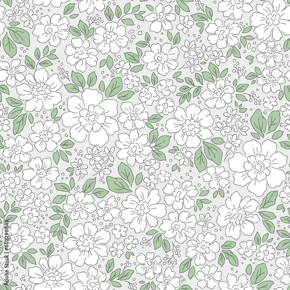 Beautiful floral pattern in small flowers. Delicate white flowers. Light gray background. Liberty print. Floral seamless background. Trendy template for fashion prints. Stock pattern.