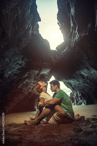 Portrait of happy couple in the hidden cave at the Querim beach, North Goa, India.