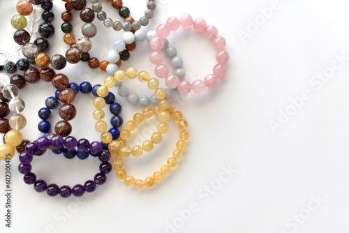 Collection of crystal gemstones bracelets on the table. 