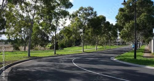 Wallpaper Mural A tree-lined suburban road in a quiet residential neighbourhood of Melbourne. Beautiful and clean living environment in a suburb. Truganina VIC Australia. Torontodigital.ca