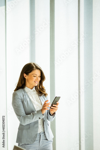 Young woman with mobile pho...