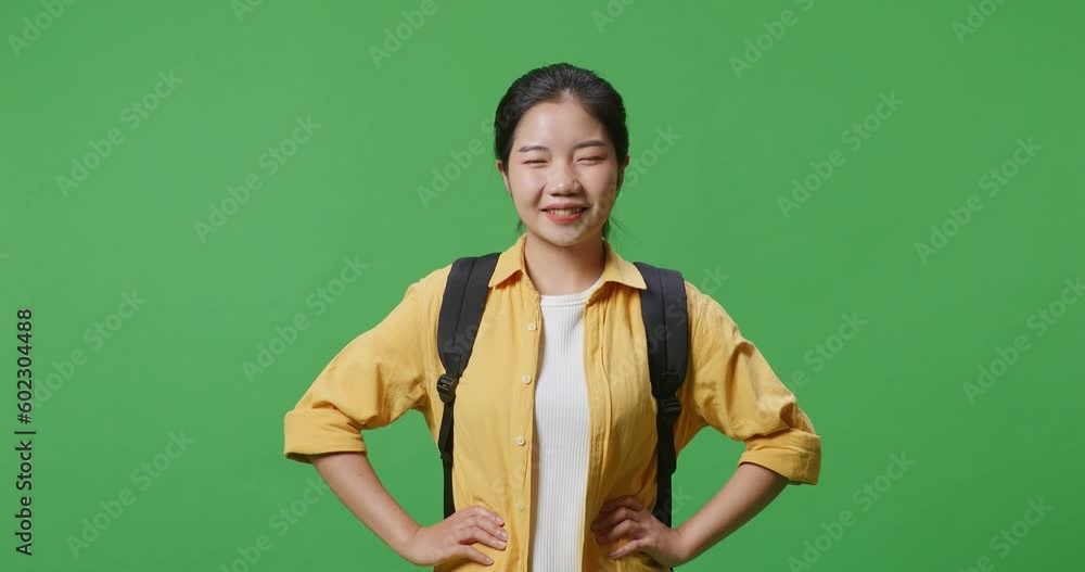 Close Up Of Asian Woman Student With A Backpack Standing With Arms Akimbo, Smiling, And Posing In The Green Screen Background Studio
Close Up Of Asian Woman Student With A Backpack Standing With Arms Akimbo, Smiling, And Posing In The Green Screen Background Studio