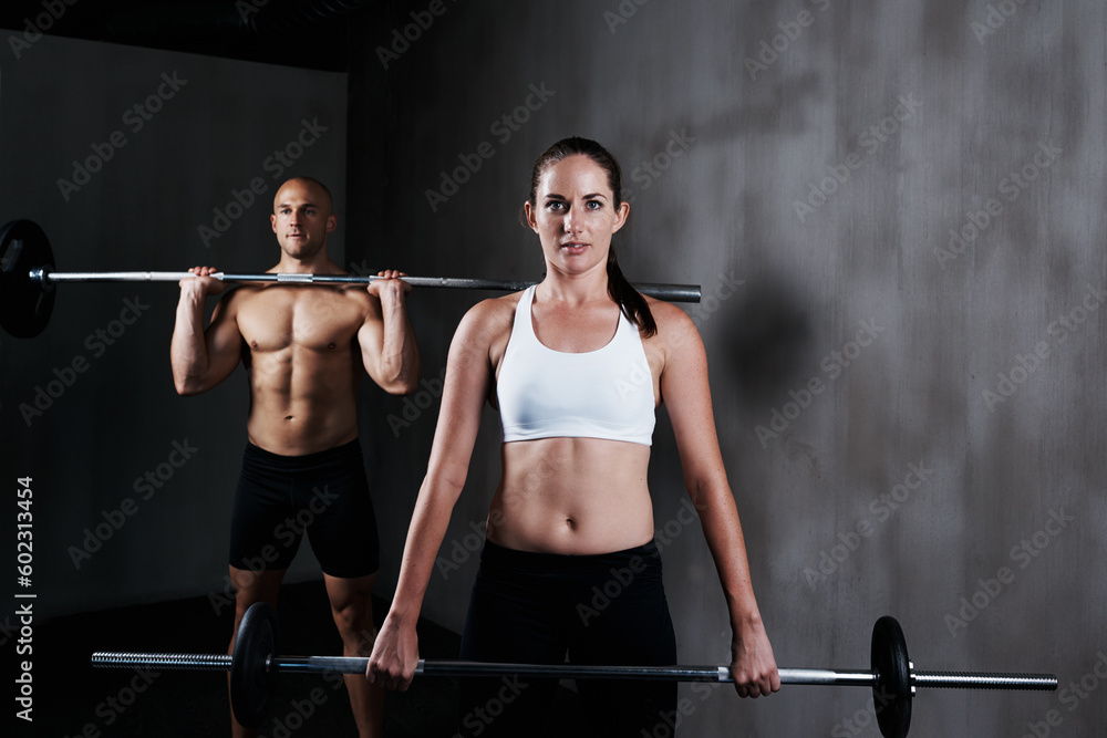 Naklejka premium Fitness, people and weightlifting with barbell for exercise, bodybuilding or workout at gym. Portrait of fit, active and strong woman and man lifting weight for intense strength, muscle or training
