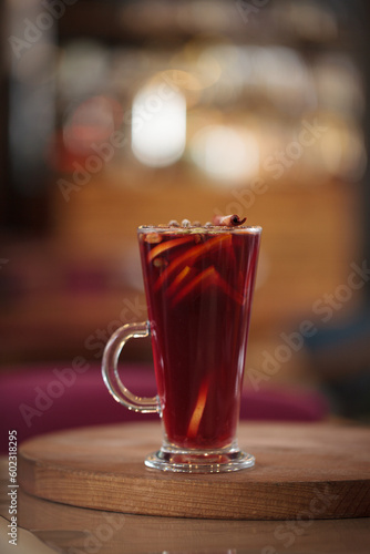 Fruit tea or mulled wine with berries in a glass cup