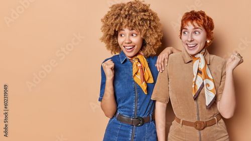 Εκτύπωση καμβά Studio shot of positive young women wear fashionable dress and kerchief around n