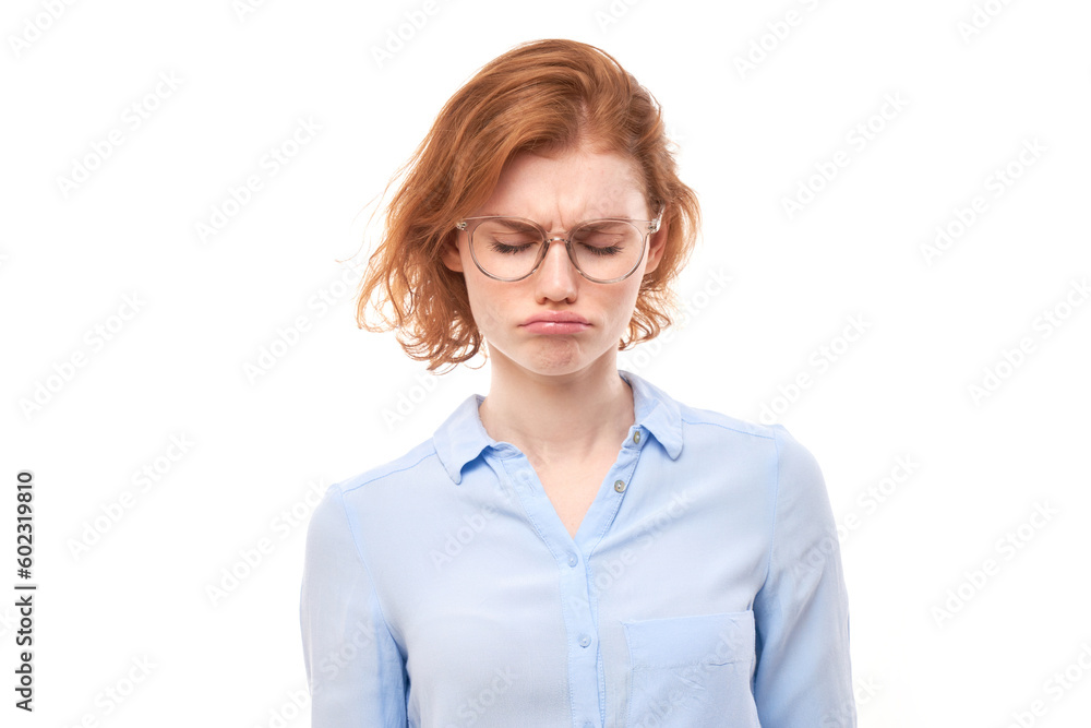 Portrait sad red-haired young woman isolated on white studio background. Made mistake, upset and depressed face Portrait sad red-haired young woman isolated on white studio background. Made mistake, upset and depressed face